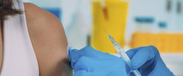 Image of arm about the receive a vaccine