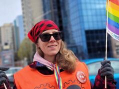 Participez à la Semaine d’actions arc-en-ciel! PSAC member with pride flag