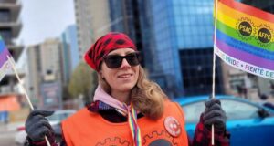 International Day Against Homophobia, Transphobia, and Biphobia: Join Rainbow Week of Action PSAC member with pride flag